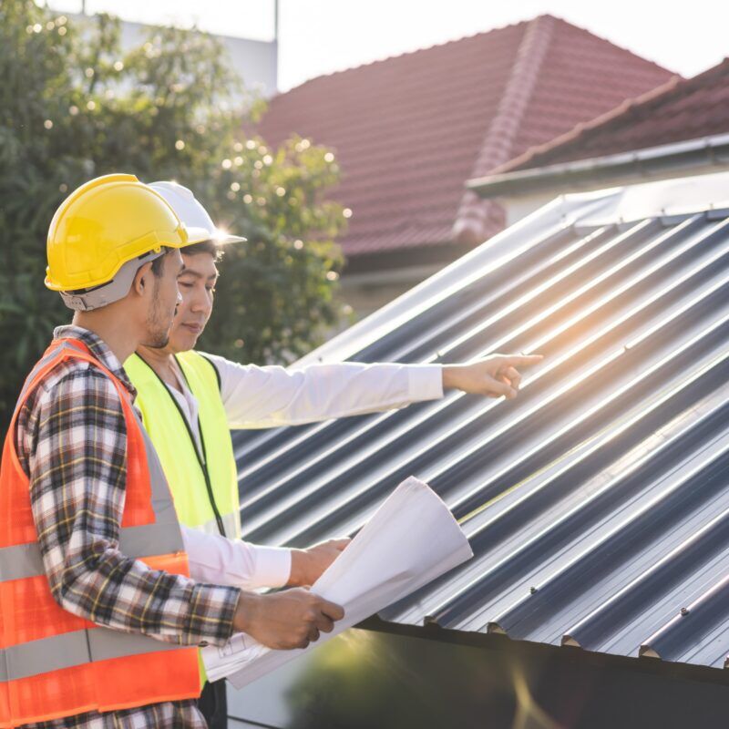 Team of experts doing a final check over recently installed metal roof over shingles